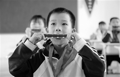 阜南县柴集镇后湖九年制学校学生在音乐课上练习吹口琴.